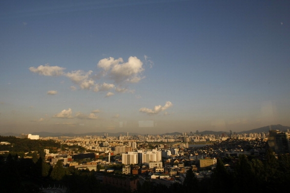 A view across the city including the mountains and skyscrapers in the Gangnam business district in Seoul, South Korea.