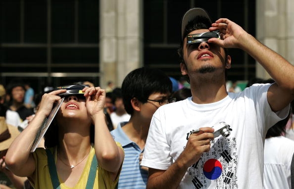Students watch the total solar eclipse at the Yonsei University in Seoul, South Korea. 