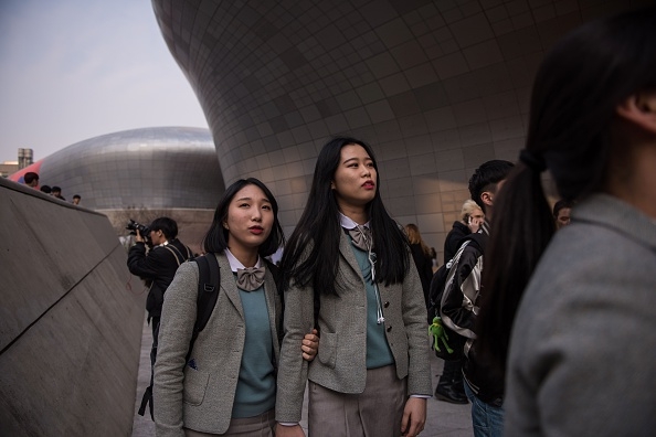 Spectators arrive for a show during Seoul fashion week at the Dongdaemun Design Plaza in Seoul on Tuesday.