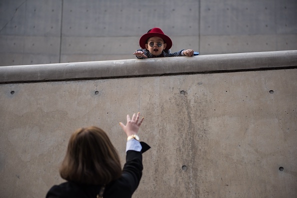 A child gestures to a woman at Dongdaemun Design Plaza, the venue where Seoul Fashion Week 2016 is being held.