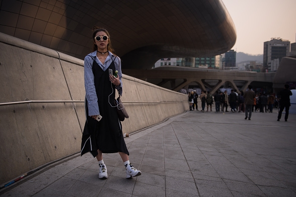 A fashion fan heads into one of the Seoul Fashion week runway exhibitions.