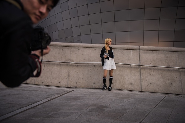 A model poses for photos outside the big show.