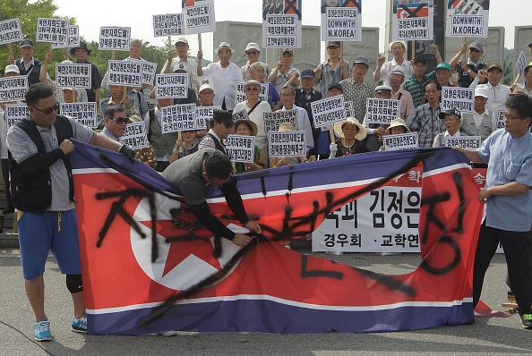 South Korean conservative protesters tear a North Korea's national flag during a anti-North Korea rally near the demilitarized zone (DMZ) at Imjingak