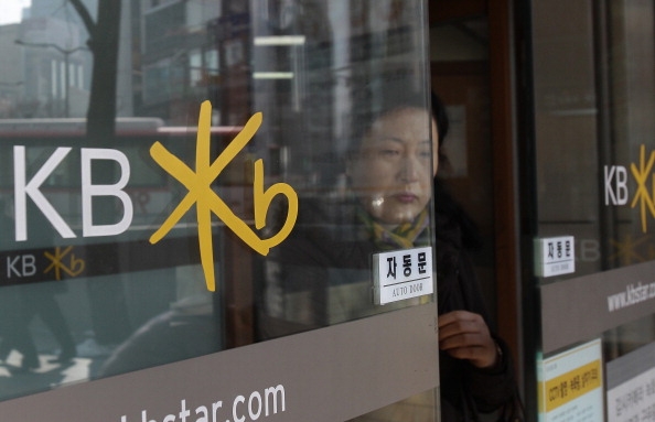 A South Korean woman leaves a branch of KB Kookmin Bank in Seoul, South Korea.