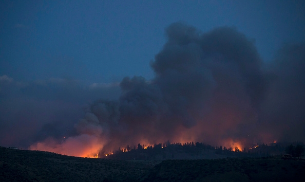 A wildfire, which is part of the Okanogan Complex, flares up on August 21, 2015 in the hills near Omak, Washington.