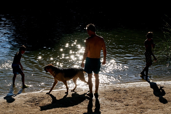 People cool off as they play in the Manzanares river near El Pardo on July 21, 2015 in Madrid, Spain.