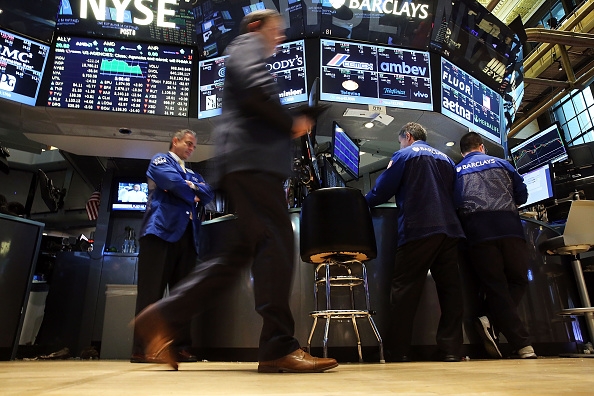  Traders work on the floor of the New York Stock Exchange (NYSE) on August 25, 2015 in New York City. Following a day of steep drops in global markets, the Dow Jones industrial average rallied early in the day only to fall over 200 points at the close.