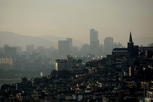 residential properties north of the Han River backdropped by mountains and skyscrapers in the Gangnam business district