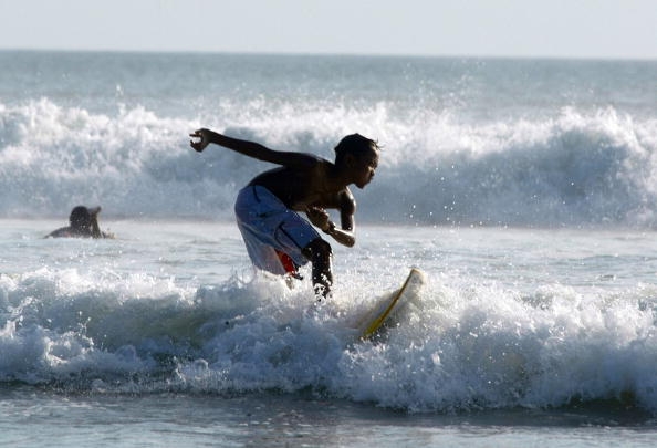 A surfer rides a small wave at Kuta beach in Bali, Indonesia, one of the best surfing spots in the world